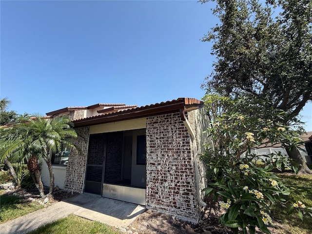 7360 Ulmerton Rd Unit 20F, Largo, FL 33771 - view of side of home with a tiled roof and stucco siding