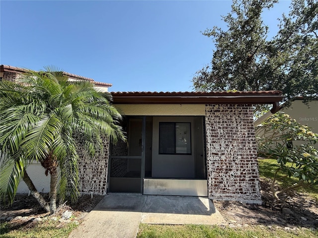 7360 Ulmerton Rd Unit 20F, Largo, FL 33771 - property entrance featuring a tiled roof and brick siding