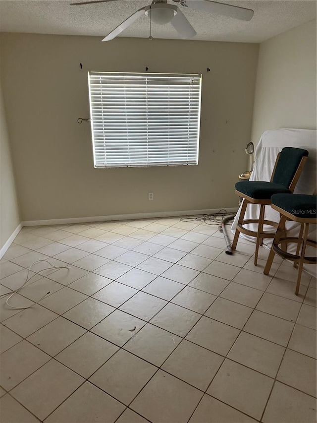 7360 Ulmerton Rd Unit 20F, Largo, FL 33771 - unfurnished room with a textured ceiling, ceiling fan, baseboards, and light tile patterned floors