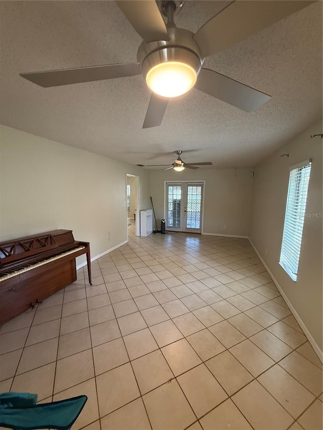 7360 Ulmerton Rd Unit 20F, Largo, FL 33771 - unfurnished living room with a textured ceiling, ceiling fan, light tile patterned flooring, and baseboards