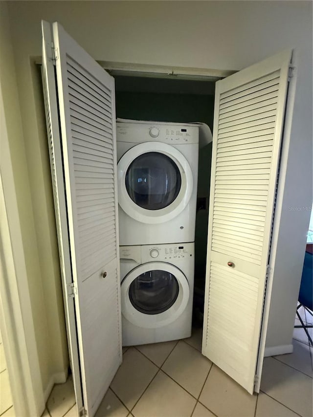 7360 Ulmerton Rd Unit 20F, Largo, FL 33771 - laundry area with stacked washing machine and dryer and light tile patterned floors