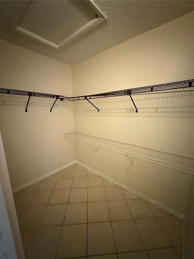 7360 Ulmerton Rd Unit 20F, Largo, FL 33771 - walk in closet featuring attic access and tile patterned floors