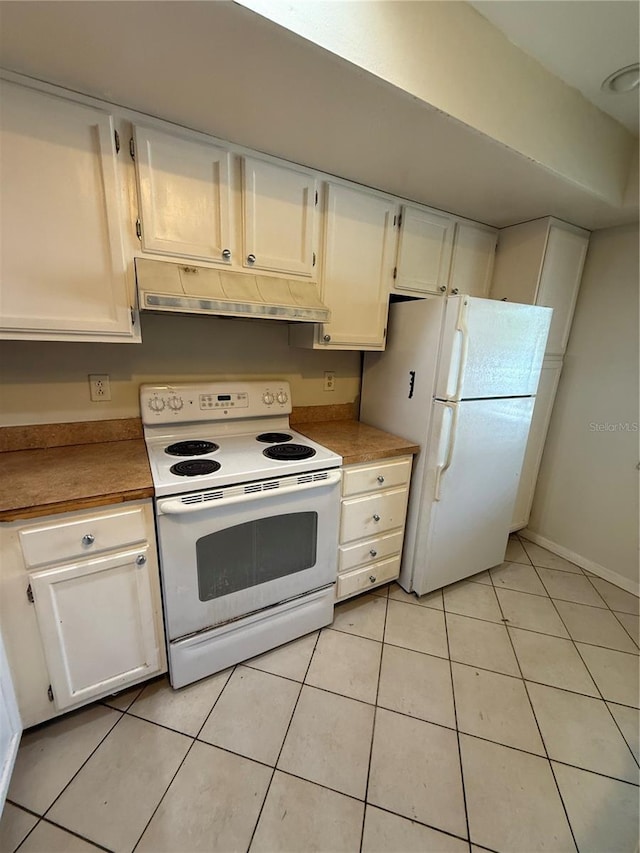 7360 Ulmerton Rd Unit 20F, Largo, FL 33771 - kitchen featuring white appliances, under cabinet range hood, white cabinetry, light tile patterned floors, and baseboards
