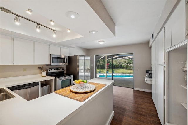 6514 Sunhigh Dr, New Port Richey, FL 34655 - kitchen featuring appliances with stainless steel finishes, light countertops, dark wood-style floors, baseboards, and white cabinets