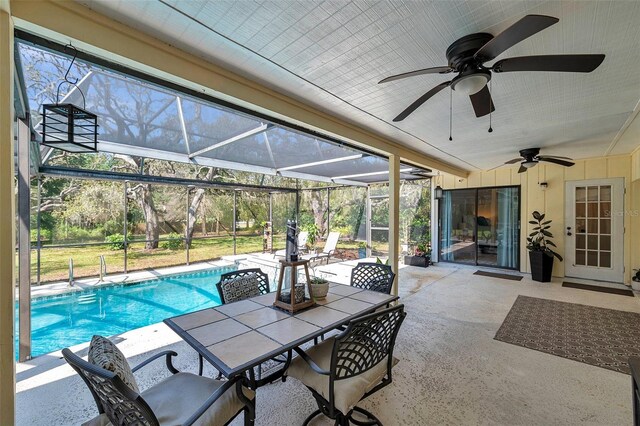 6514 Sunhigh Dr, New Port Richey, FL 34655 - view of patio featuring ceiling fan, glass enclosure, an outdoor pool, and outdoor dining area
