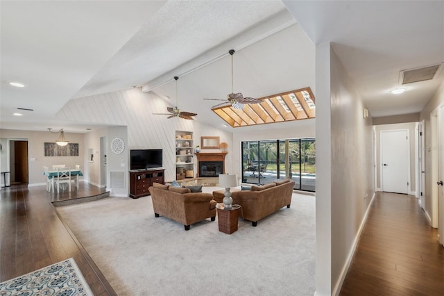 6514 Sunhigh Dr, New Port Richey, FL 34655 - living room with wood-type flooring, baseboards, a ceiling fan, and a glass covered fireplace