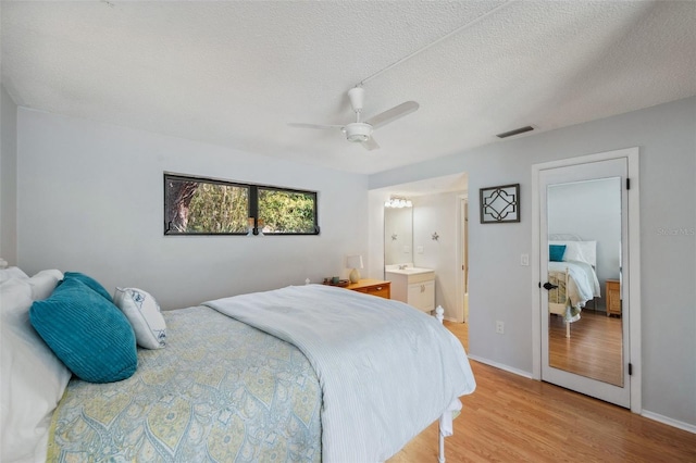6514 Sunhigh Dr, New Port Richey, FL 34655 - bedroom featuring light wood finished floors, a textured ceiling, a ceiling fan, baseboards, and ensuite bathroom