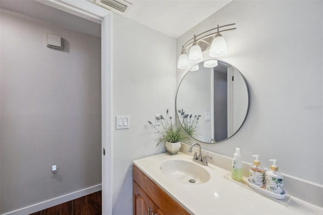 6514 Sunhigh Dr, New Port Richey, FL 34655 - bathroom with wood finished floors, vanity, and baseboards