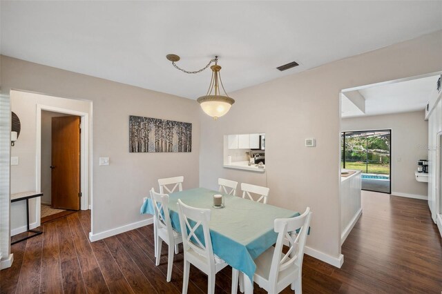 6514 Sunhigh Dr, New Port Richey, FL 34655 - dining space featuring dark wood-type flooring and baseboards