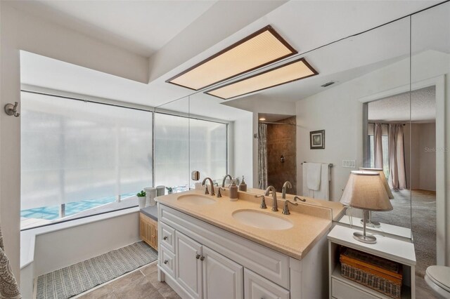 6514 Sunhigh Dr, New Port Richey, FL 34655 - bathroom featuring toilet, double vanity, a shower, and tile patterned flooring