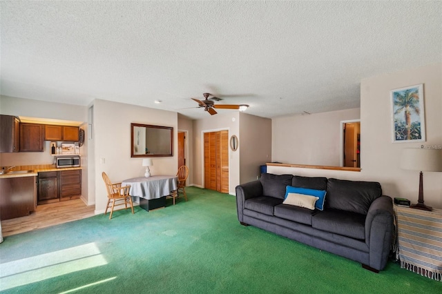 6514 Sunhigh Dr, New Port Richey, FL 34655 - living room featuring light carpet, a textured ceiling, a ceiling fan, and baseboards