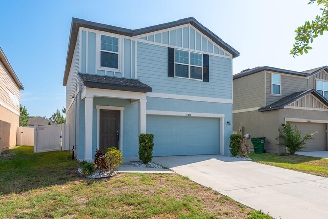 view of front of home featuring a garage, driveway, board and batten siding, and stucco siding