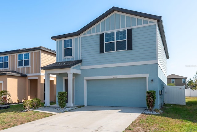view of front facade featuring a garage, concrete driveway, and stucco siding