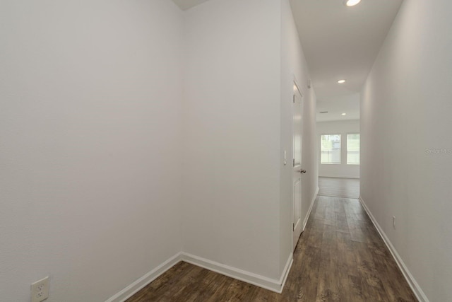 corridor with recessed lighting, dark wood-type flooring, and baseboards