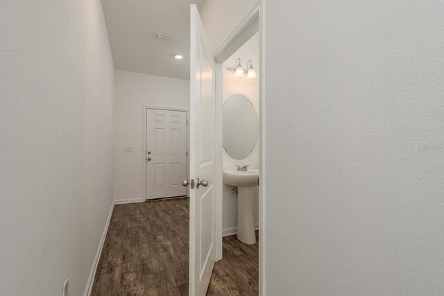 bathroom with wood finished floors and baseboards