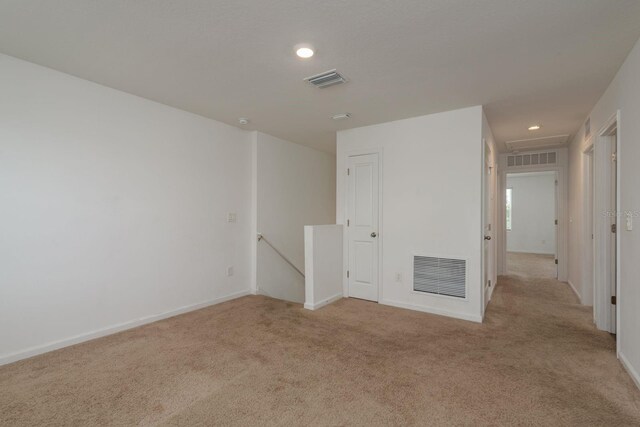 spare room with carpet floors, recessed lighting, and baseboards