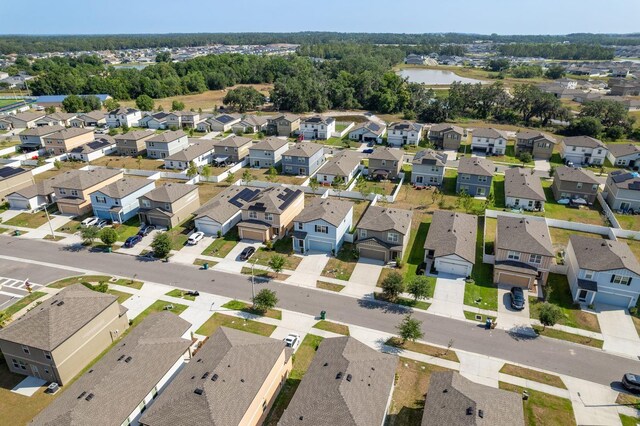 aerial overview of property's location with a nearby body of water and nearby suburban area