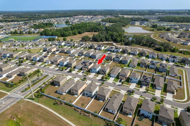 aerial overview of property's location featuring a nearby body of water and nearby suburban area