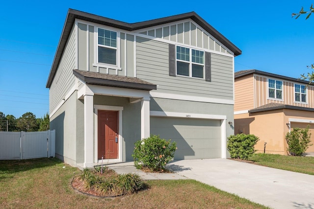 view of front facade featuring an attached garage, driveway, stucco siding, and board and batten siding