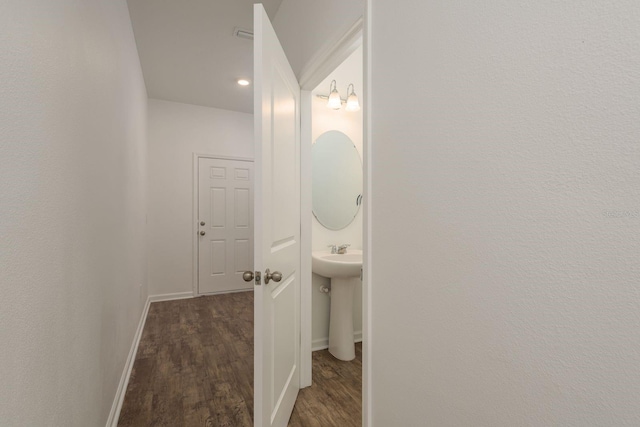 half bath featuring wood finished floors, baseboards, and recessed lighting