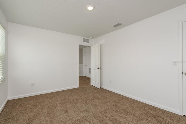 empty room with carpet and baseboards