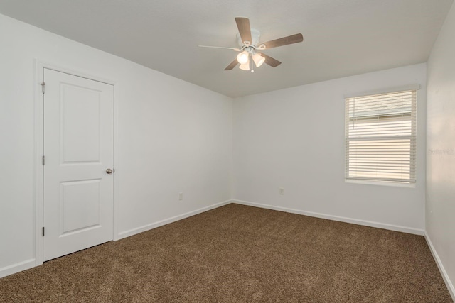 empty room featuring carpet floors, ceiling fan, and baseboards