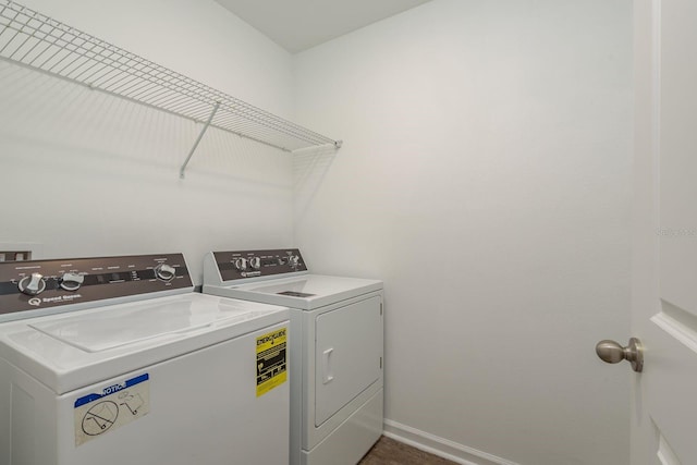 laundry room featuring washer and dryer and baseboards