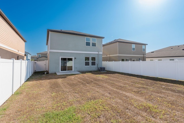 rear view of house with central air condition unit and stucco siding