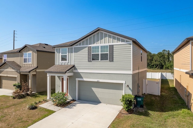 multi unit property featuring a garage, concrete driveway, stucco siding, board and batten siding, and a front lawn