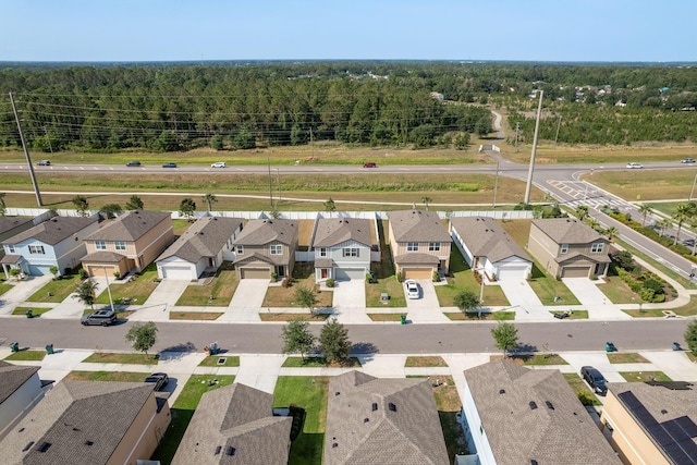 aerial view of residential area featuring a heavily wooded area