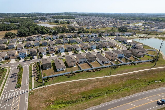 aerial perspective of suburban area with a nearby body of water