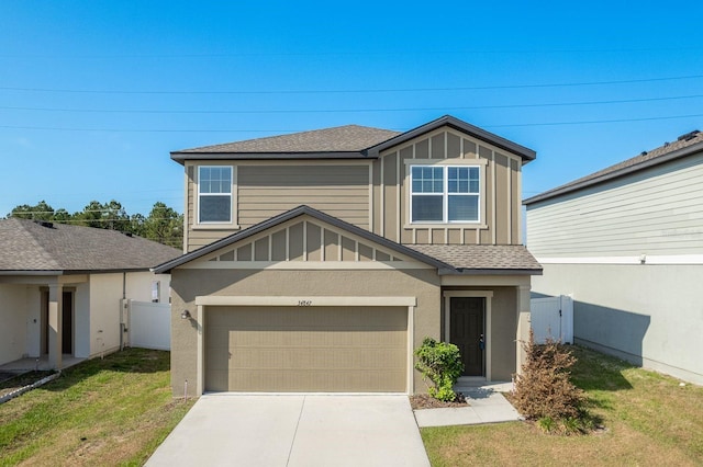 view of front of home featuring board and batten siding, driveway, roof with shingles, a garage, and a gate