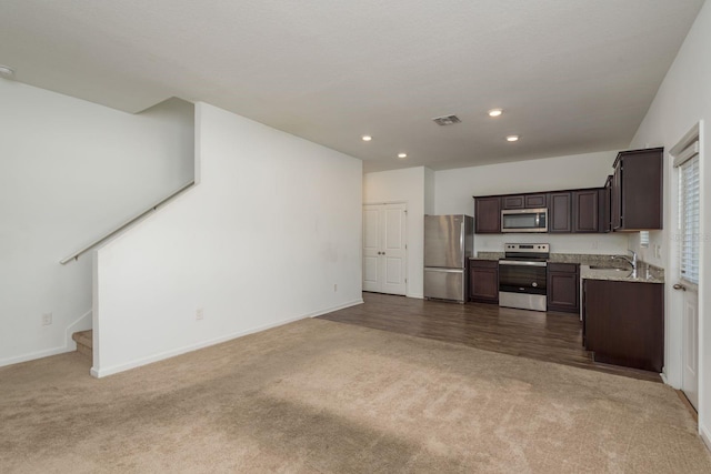 kitchen featuring appliances with stainless steel finishes, carpet floors, open floor plan, and recessed lighting