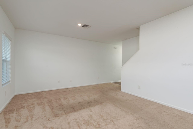 spare room featuring carpet floors, baseboards, and recessed lighting