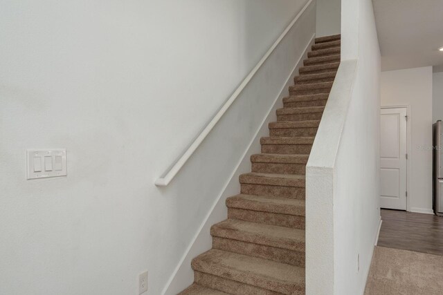 stairs featuring carpet floors