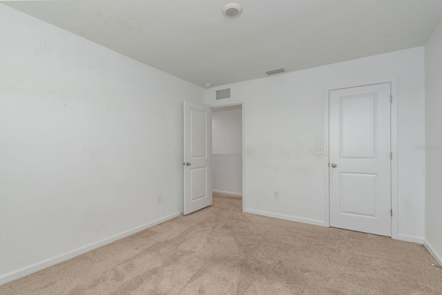 carpeted spare room with baseboards