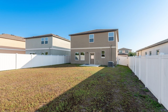 rear view of house featuring central AC unit and a patio