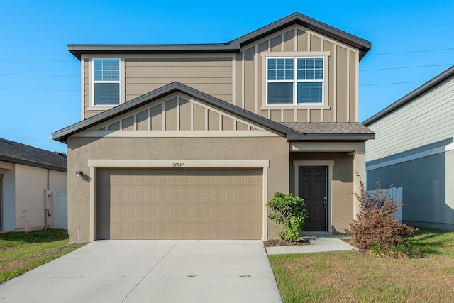 view of front of house with a garage, board and batten siding, driveway, and stucco siding