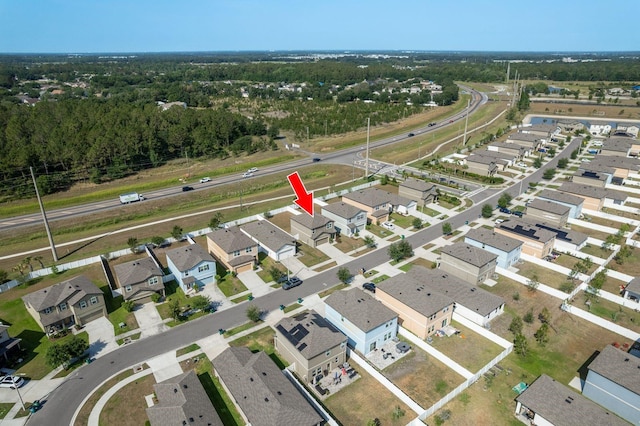 aerial view of property and surrounding area with nearby suburban area