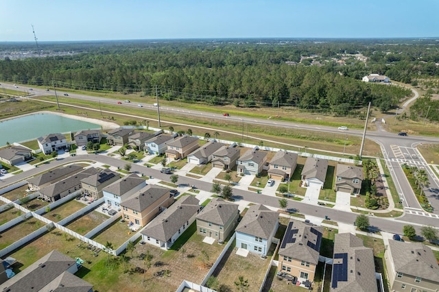 aerial overview of property's location featuring a forest and nearby suburban area