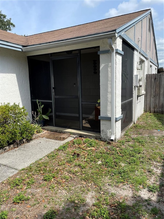 exterior space featuring fence and a sunroom