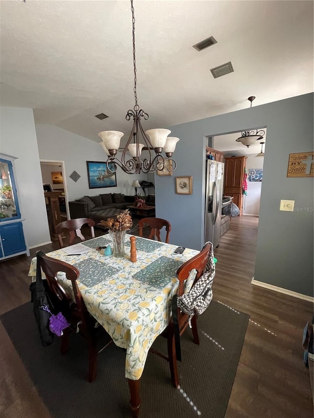 dining room featuring visible vents, dark wood-style flooring, and a notable chandelier