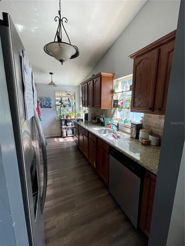 kitchen with dark wood-style flooring, a healthy amount of sunlight, appliances with stainless steel finishes, backsplash, and vaulted ceiling