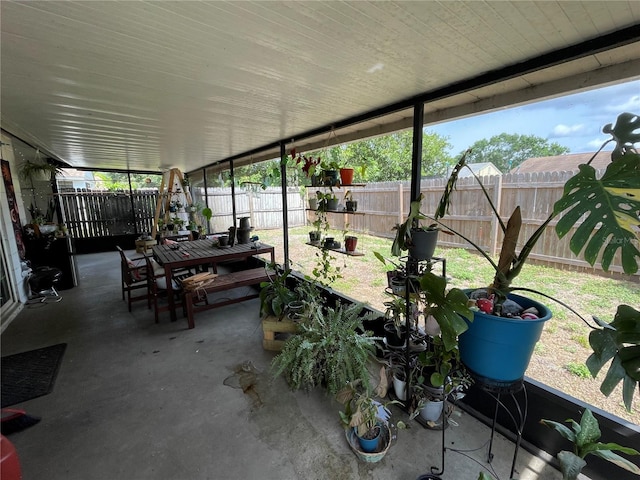 sunroom / solarium featuring outdoor dining area