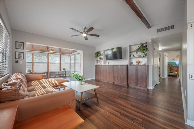 living area featuring a healthy amount of sunlight, ceiling fan, dark wood-type flooring, and visible vents