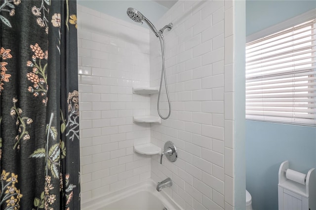 bathroom featuring shower / tub combo with curtain and toilet