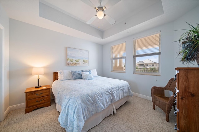 17735 Gulf Blvd Unit 304, Redington Shores, FL 33708 - bedroom featuring light carpet, a raised ceiling, baseboards, and ceiling fan