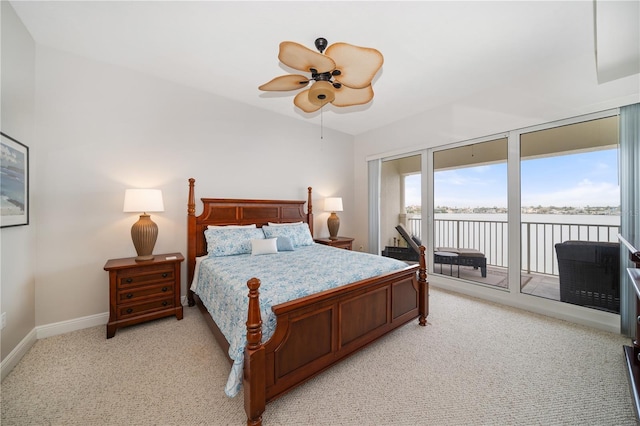 17735 Gulf Blvd Unit 304, Redington Shores, FL 33708 - bedroom featuring access to outside, light colored carpet, a water view, and a ceiling fan