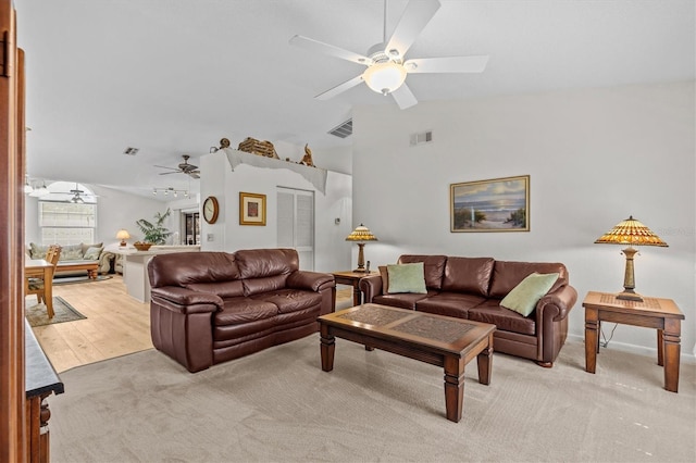 living area featuring ceiling fan, vaulted ceiling, and light carpet