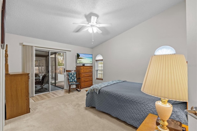 carpeted bedroom with access to outside, a textured ceiling, vaulted ceiling, and ceiling fan